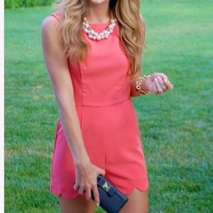 Coral romper with scalloped shorts and open back